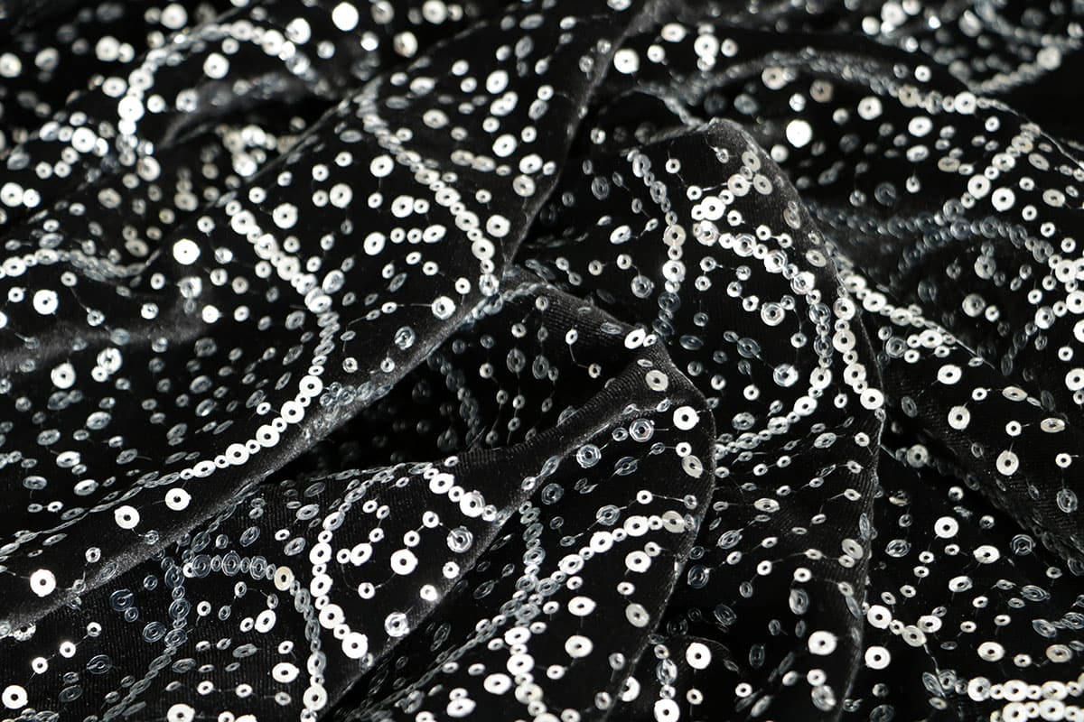 Elegante tessuto nero con paillettes e ricami argentati | new tess