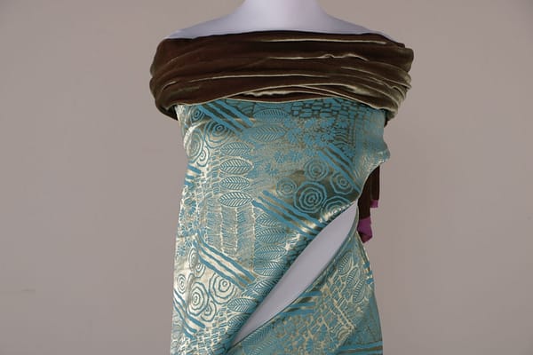 Turquoise apparel fabric with gold decoration | new tess