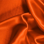 Tessuto Crêpe Satin Arancione Corallo in Seta per abbigliamento