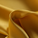 Oil yellow crêpe back satin fabric | new tess