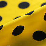 Silk satin fabric printed with a dark blue maxi polka dot motif on a yellow background | new tess