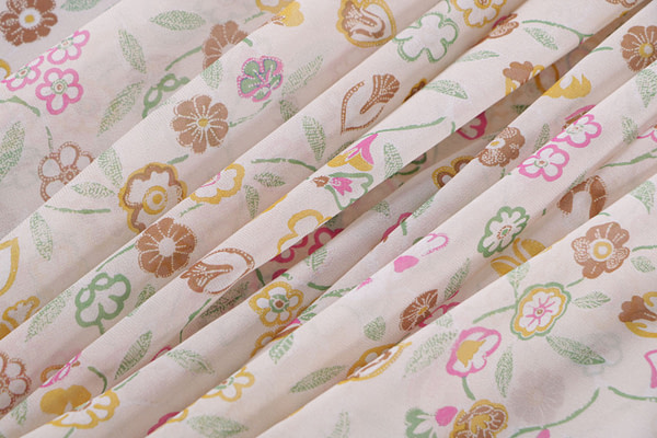 Silk georgette fabric printed in a multicoloured allover floral pattern on a ivory background | new tess