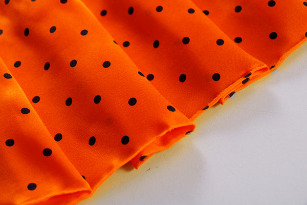 Orange polka dot silk satin fabric | new tess