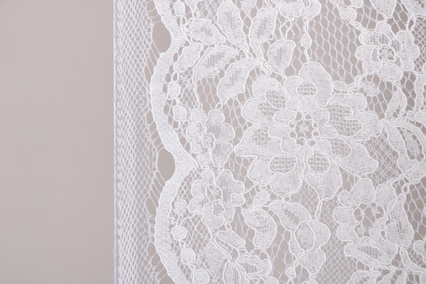 Bridal rebrodé lace fabric in ivory with double scalloping