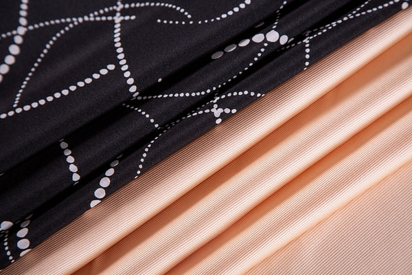 Black polka dot silk crepe and peach silk dogaressa fabric | new tess