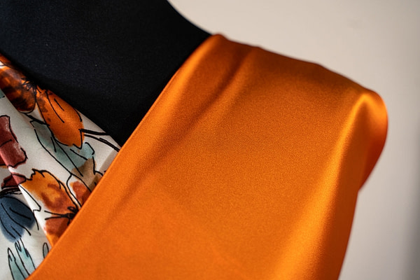 Persimmon orange crêpe back satin fabric | new tess